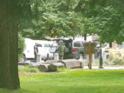 A Vancouver Police Department Bomb Unit officer responds to a call at Esther Short Park on Friday. A Clark County Dispatcher said a man wearing a mask left a bag at the park.