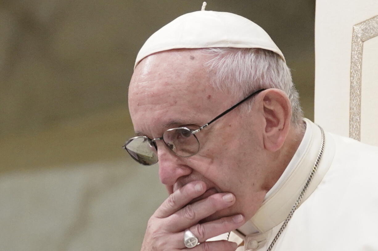 FILE - In this Aug. 22, 2018 file photo, Pope Francis is caught in pensive mood during his weekly general audience at the Vatican. Francis’ papacy has been thrown into crisis by accusations that he covered-up sexual misconduct by ex-Cardinal Theodore McCarrick.