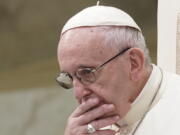 FILE - In this Aug. 22, 2018 file photo, Pope Francis is caught in pensive mood during his weekly general audience at the Vatican. Francis’ papacy has been thrown into crisis by accusations that he covered-up sexual misconduct by ex-Cardinal Theodore McCarrick.