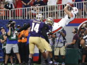 Auburn tight end Sal Cannella (80) makes a catch for a touchdown as Washington defensive backs Jordan Miller (23) and JoJo McIntosh (14) defend in the first half of an NCAA college football game Saturday, Sept. 1, 2018, in Atlanta.