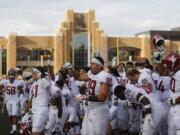 Washington State players recognize their fans in the stands Saturday, Sept. 1, 2018, at War Memorial Stadium in Laramie, Wayo. Washington State defeated Wyoming 41-19 in an NCAA college football game.