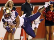 Washington running back Myles Gaskin (9) scores against Utah in the first half during an NCAA college football game Saturday, Sept. 15, 2018, in Salt Lake City.