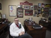 Camas Mayor Scott Higgins sits surrounded by Papermakers paraphernalia in his downtown office in November 2017.