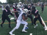 Seton Catholic's CJ Hamblin rushes for a first down during Saturday's 40-0 victory over Fort Vancouver. Hamlin led the Cougars in rushing and receiving yards.