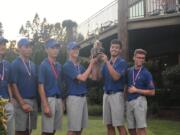 Ridgefield golf team members hoist the district championship trophy after winning the team title at the 2A district golf tournament at Lewis River (Meg Wochnick/The Columbian)