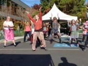 A flash mob of dancers performs the “Thriller” dance Saturday afternoon during the Vancouver Farmers Market. The dancers captured the market’s attention for only a few moments and left nearly as quickly as they arrived.