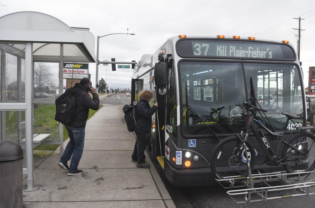 Greg Smith, left, and Nathaniel Baker board a bus in February on Mill Plain Boulevard near the intersection of Southeast 136th Avenue.