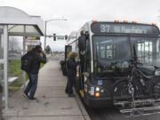 Greg Smith, left, and Nathaniel Baker board a bus in February on Mill Plain Boulevard near the intersection of Southeast 136th Avenue.