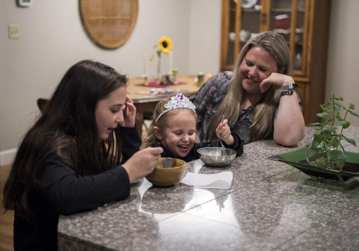 Lacey Wescom, 12, from left, her sister Tillie Thornber, 3, and their mother Wendi Thornber eat ice cream together on Sept. 19 at their home in Hazel Dell. The family used to be homeless, but has made significant strides. This summer Wendi Thornber graduated from Clark College and began a full-time job with PeaceHealth.