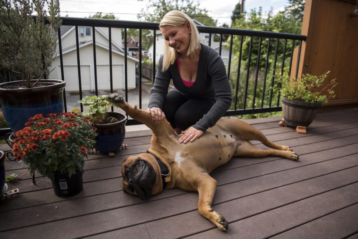 Irene Gielen and her bull mastiff, Alice, are pictured at her home in Vancouver. Gielen tested positive for the BRCA1 gene in 2016 and since then has had multiple surgeries to reduce her risk of cancer. Gielen had a double mastectomy first and is currently healing from getting her ovaries and fallopian tubes removed in late August.