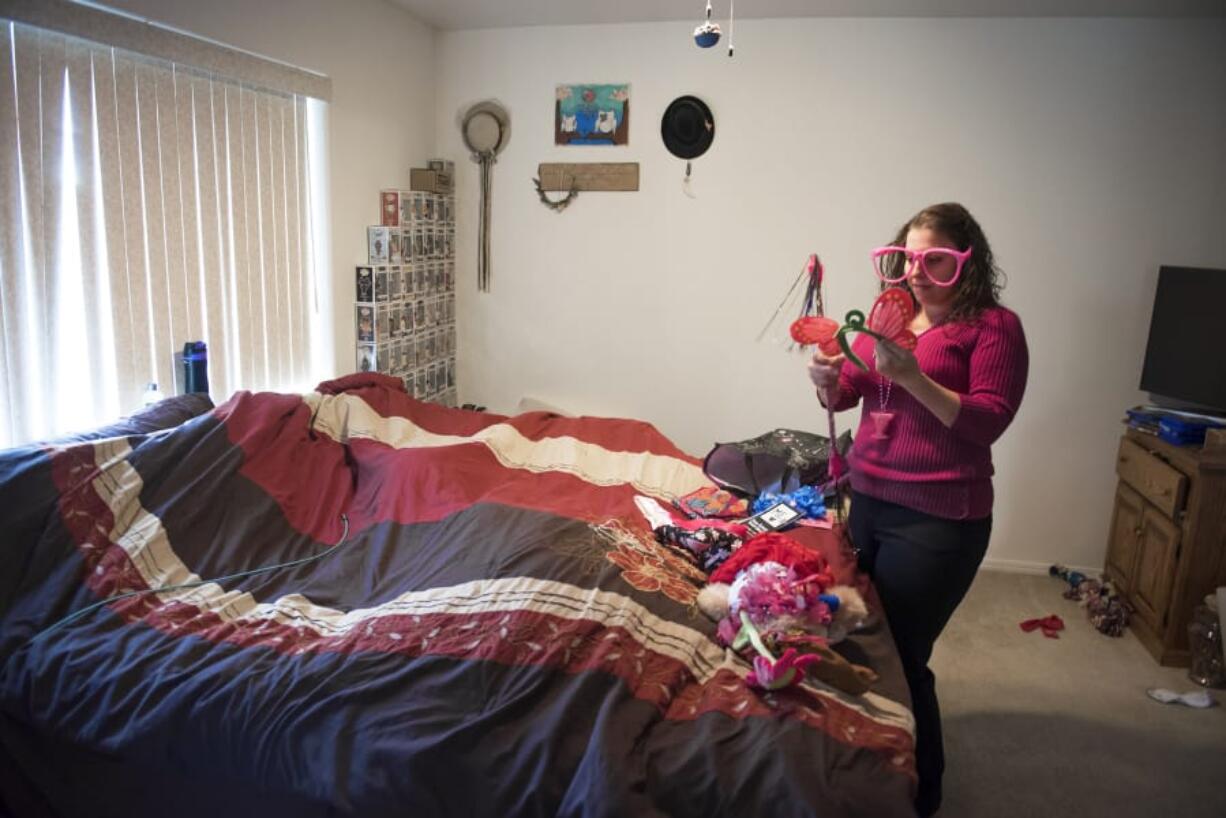 Adrienne San Nicolas pauses at her Vancouver home to examine a butterfly-wing headband that belonged to friend Tammy Townsend, who died of breast cancer in February 2016, while sorting through items she collected during chemotherapy.