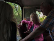 Eileen Quiring chats about her plans for a rail development that she hopes will create good-paying jobs, while on a tour of the Chelatchie Prairie Railroad. Dave Nelson, right, a Clark County Railroad Advisory Board member, surveys the line.