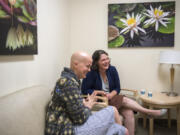 Jana Cox of Vancouver, left, meets with oncology surgeon Dr. Cory Donovan at Legacy Salmon Creek Medical Center. Cox was diagnosed with triple-negative breast cancer in April and just finished eight rounds of chemotherapy. As a survivor of triple-negative breast cancer, Donovan said she sees a lot of herself in Cox.