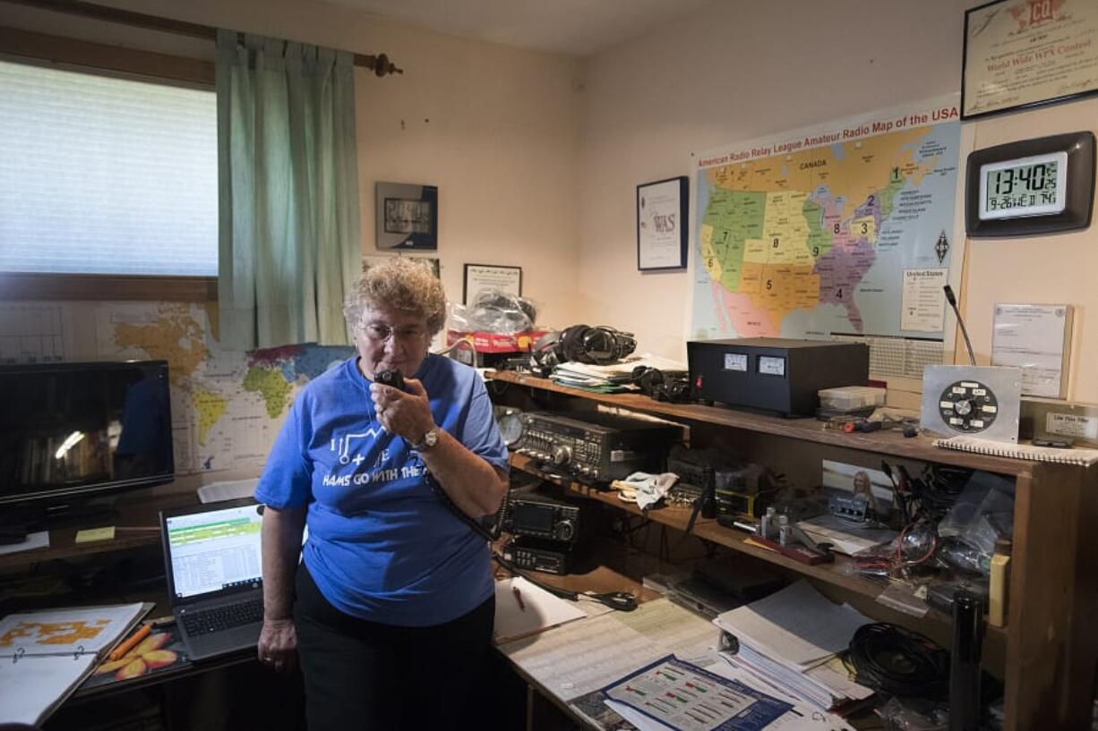 Barbara Yasson of Salmon Creek makes contact with a friend in Cascade Park via radio waves during a demonstration at her home.