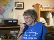 Barbara Yasson of Salmon Creek chats with a friend in Cascade Park via radio waves during a demonstration at her home.