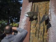 Mike Bighaus of Rainier, Ore., pauses to snap a photo of the clock tower in Esther Short Park. The tower and its glockenspiel were the gift of local philanthropist George Propstra.