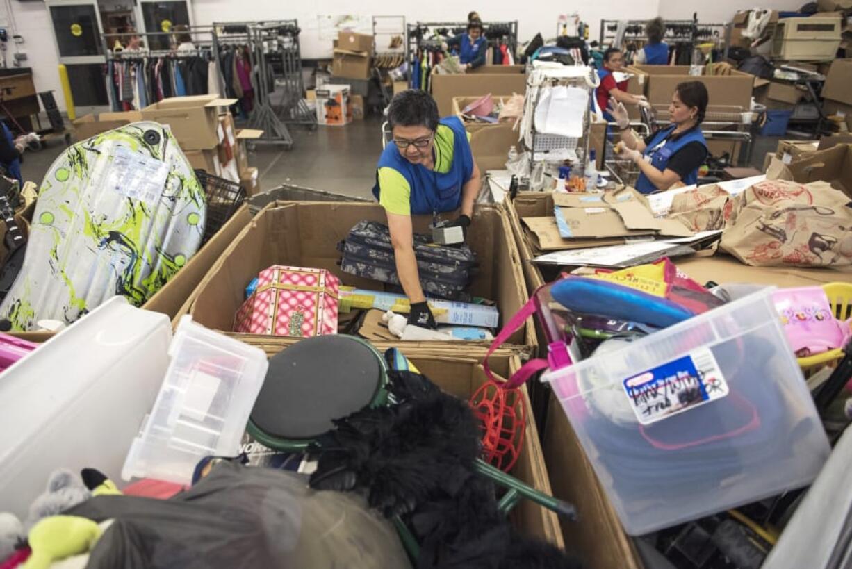 Lucia Mercado, Goodwill production associate, sorts through donations at the Fisher’s Landing Goodwill in east Vancouver. In the last year, more than 250 million pounds of household items were donated to Goodwill Industries of the Columbia Willamette. If an item’s price is too high, causing it not to sell, it goes to a Goodwill Outlet location.