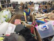 Lucia Mercado, Goodwill production associate, sorts through donations at the Fisher’s Landing Goodwill in east Vancouver. In the last year, more than 250 million pounds of household items were donated to Goodwill Industries of the Columbia Willamette. If an item’s price is too high, causing it not to sell, it goes to a Goodwill Outlet location.