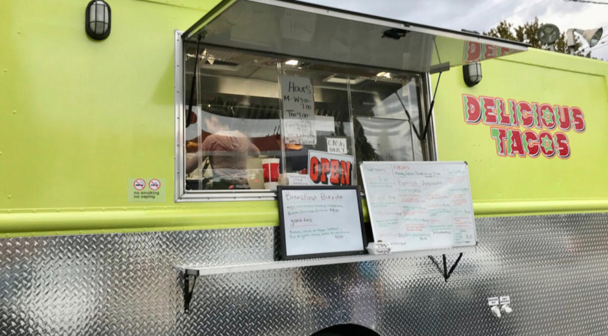 Camerina and Carolina Arciga make tacos inside their Delicious Tacos truck in Vancouver.