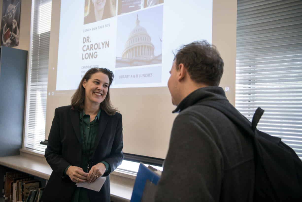 Carolyn Long, a Democrat running for the 3rd Congressional District, speaks with Camas High School senior Parker Shaw after students gathered to hear Long speak during the DECA Girls Represent lunchtime series event on Tuesday.