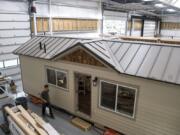 Wolf Industries employees work on one of the tiny modular homes at the company’s new shop in Battle Ground. The company, started by Battle Ground High School grad Derek Huegel, has grown since switching over to building tiny homes full time in 2016, and was recently hired by the nonprofit Homes for Sonoma to build and ship tiny homes to California to help families displaced by wildfires.