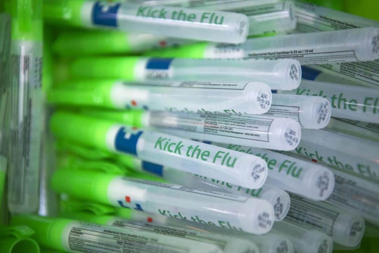 Free hand sanitizers are given out during the Kick The Flu event for hospital employees at Legacy Salmon Creek Medical Center in October 2018.