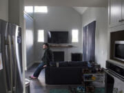 Tristan Graham, 32, sits on his couch in his new accessory dwelling unit, which was built in his parents’ backyard near Five Corners. Construction took five months.