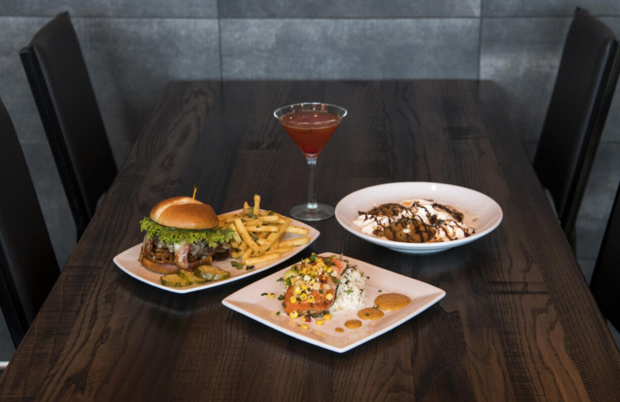 The Twigs Signature Burger with signature fries, clockwise from left, a Mango Pomegranate martini, the Sticky Cookie and the Peppered Salmon at Twigs Bistro & Bar at The Waterfront Vancouver.