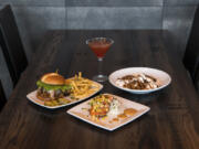 The Twigs Signature Burger with signature fries, clockwise from left, a Mango Pomegranate martini, the Sticky Cookie and the Peppered Salmon at Twigs Bistro & Bar at The Waterfront Vancouver.