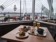 Alaskan snow crab stuffed cod, from left, is served with the WildFin burger and clams northwest style at WildFin American Grill on Wednesday morning, Oct. 10, 2018. Also pictured are the WildFin Hefeweizen, with lemon, and the WildFin Blond.