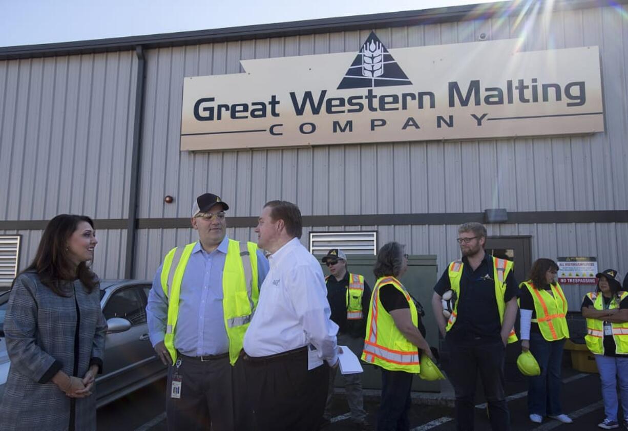 Rep. Jaime Herrera Beutler, from left, chats with Mike O’Toole, president of Great Western Malting, and Kris Johnson, president and CEO of Association of Washington Business, during a visit Friday morning to the Port of Vancouver.