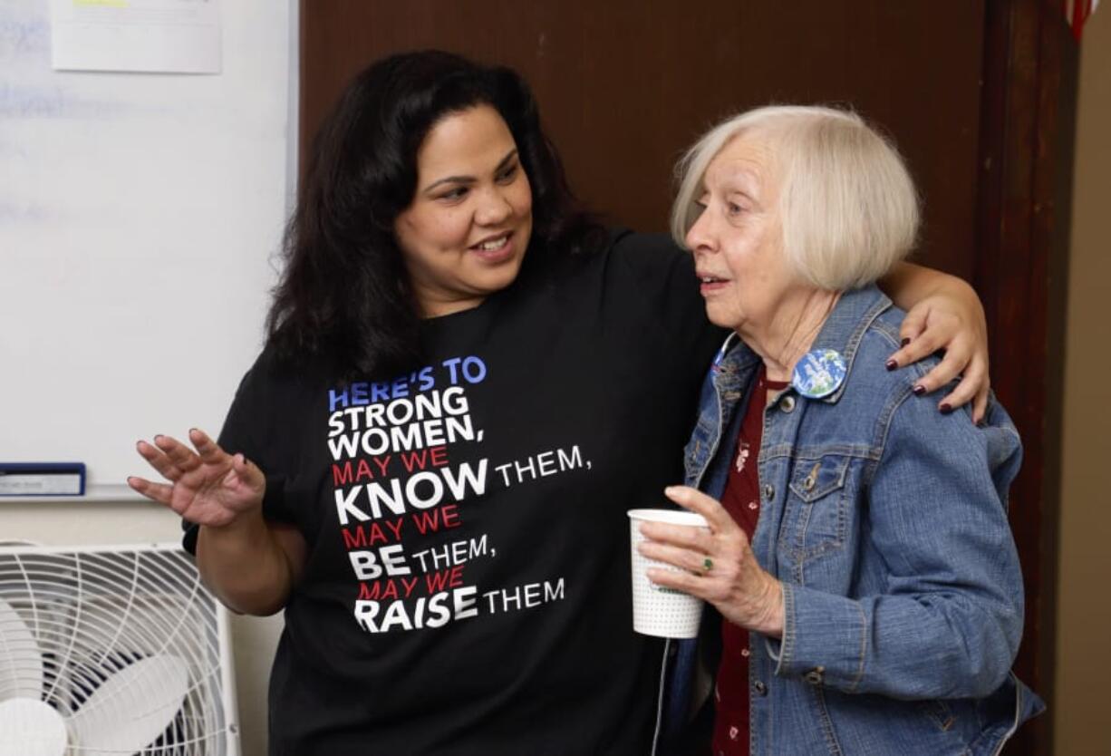 Tanisha Harris, left, visits with campaign volunteer Alice Perry Linker before she goes out to canvass voters.