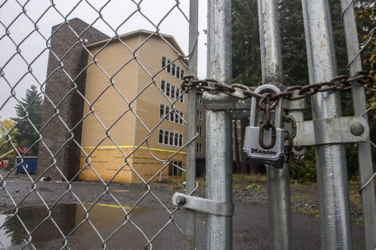 A locked fence surrounds the 134th Street Lofts complex at the corner of Northeast 134th Street and 23rd Avenue on Monday.