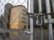 A locked fence surrounds the 134th Street Lofts complex at the corner of Northeast 134th Street and 23rd Avenue on Monday.