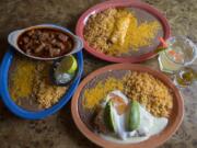 The chili colorado, from left, with chicken enchiladas, the El Jefe margarita and the seafood chimichanga.