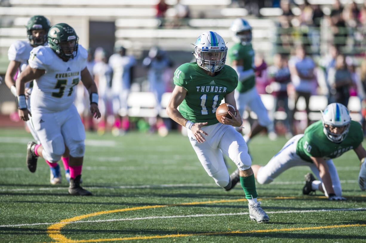 Mountain View's Garrett Moen runs the ball against Evergreen defender at McKenzie Stadium on Thursday night, Oct. 11, 2018.