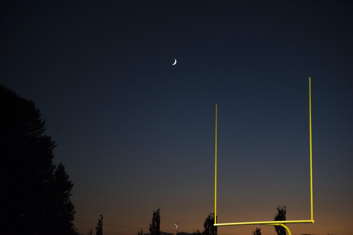 The moon rises over the Woodland, Ridgefield game at Woodland High School on Friday night, Oct. 12, 2018.