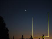 The moon rises over the Woodland, Ridgefield game at Woodland High School on Friday night, Oct. 12, 2018.