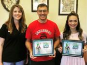 Landover-Sharmel: California Casualty’s Erica Reich, from left, presents a Music and Arts Grant to Endeavour Elementary School teachers Rocky Baker and Grace Klodt to help fund art projects for their classes.