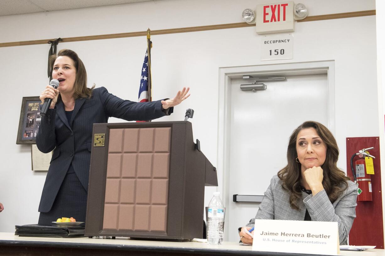 Carolyn Long, Democratic candidate for the 3rd Congressional District, left, gives her closing statement while Incumbent U.S. Rep. Jaime Herrera Beutler, R-Battle Ground, reacts during an Oct. 17 forum at Goldendale Grange Hall.