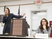 Carolyn Long, Democratic candidate for the 3rd Congressional District, left, gives her closing statement while Incumbent U.S. Rep. Jaime Herrera Beutler, R-Battle Ground, reacts during an Oct. 17 forum at Goldendale Grange Hall.