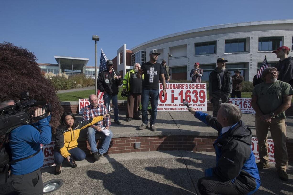 Media and supporters surround Patriot Prayer leader Joey Gibson as he speaks out in favor of Second Amendment rights at Clark College on Monday afternoon. Classes were canceled in anticipation of the demonstration.