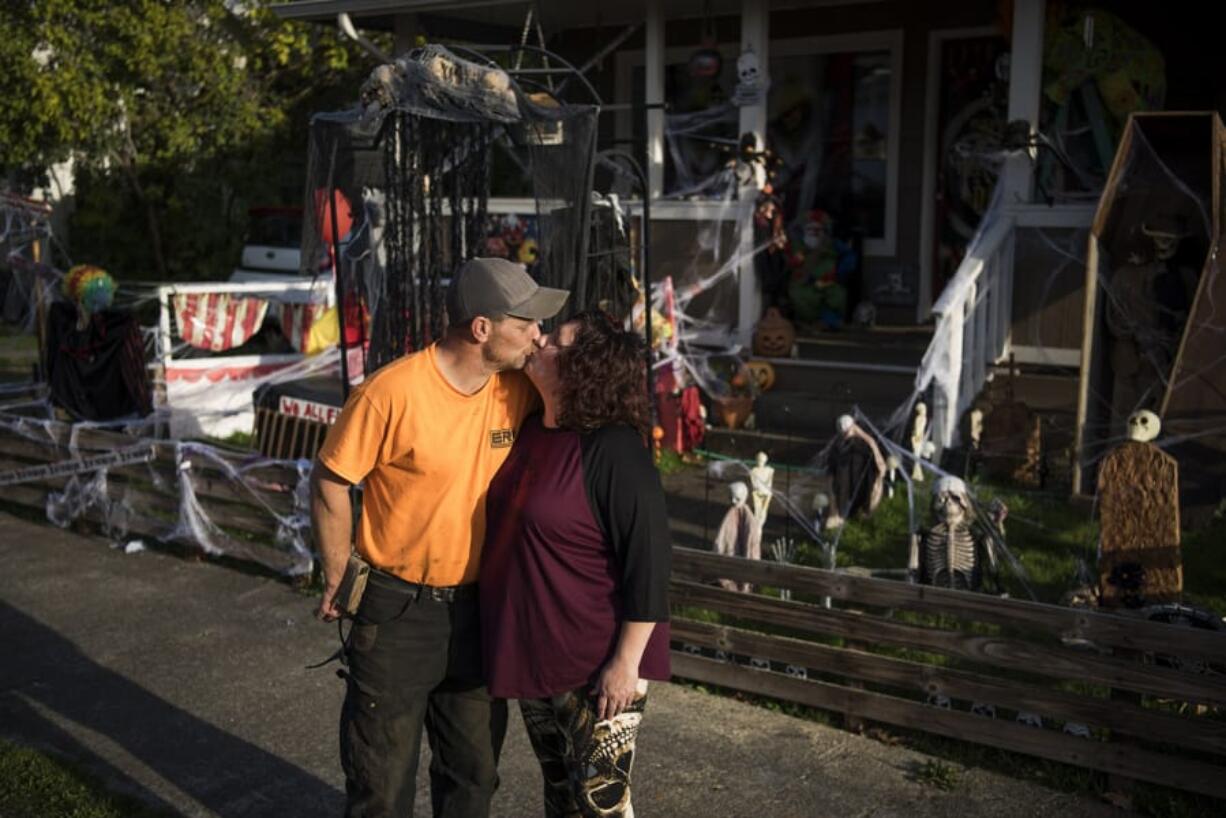 Dawn and Frank Lott are pictured outside their home in Camas. The couple were married over the summer and created “his” and “hers” sides of the lawn for Halloween. Dawn Lott’s side features scary clowns, and Frank Lott’s side features a homemade coffin and tombstones.