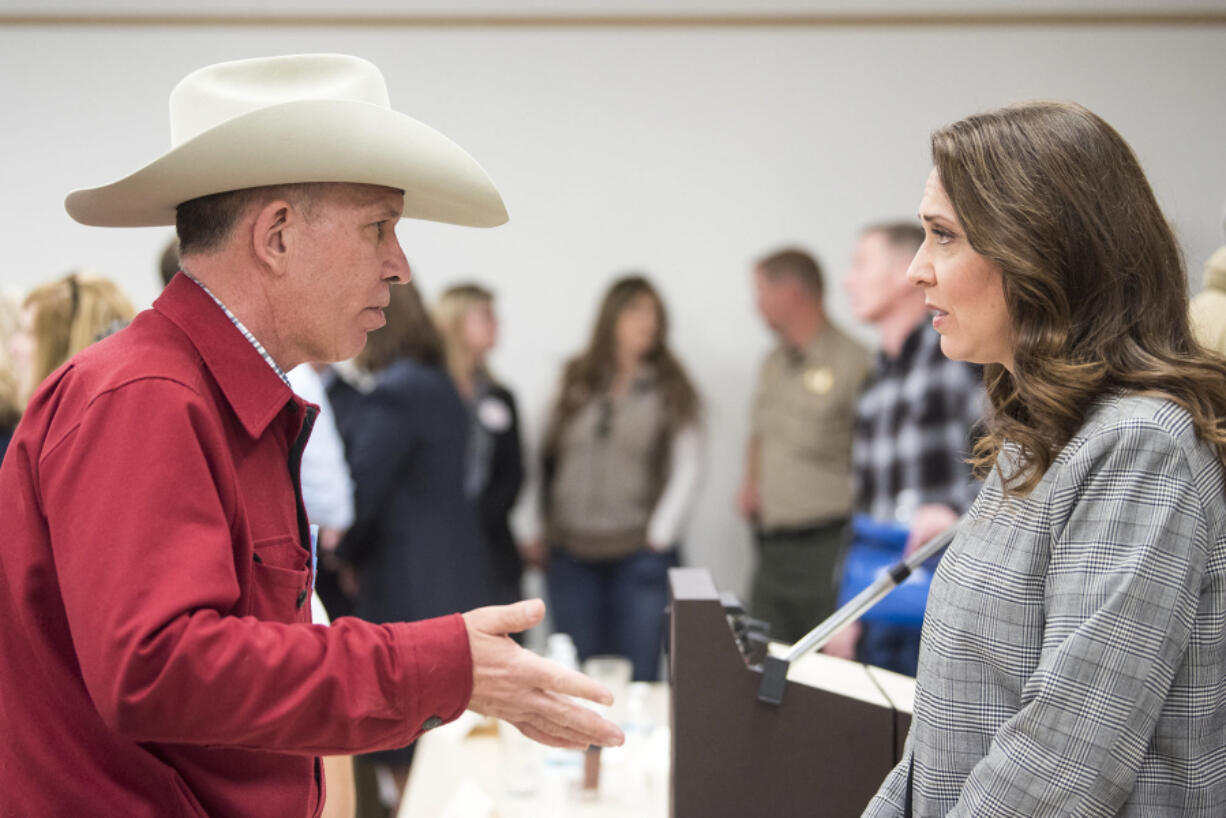 Charlie Wilson of White Salmon, left, speaks with Rep. Jaime Herrera Beutler, R-Battle Ground, following the candidate forum Wednesday in Goldendale.