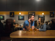 Matt Jeckel, left, and Stacy Chao have a lively conversation during a release event for MightyHighPA, a collaborative beer by Wingman Brewing, Boundary Bay Brewing, and Trap Door Brewing, at Trap Door’s taproom in Vancouver earlier this month. MightyHighPA is the first cannabis terpene beer in Washington.