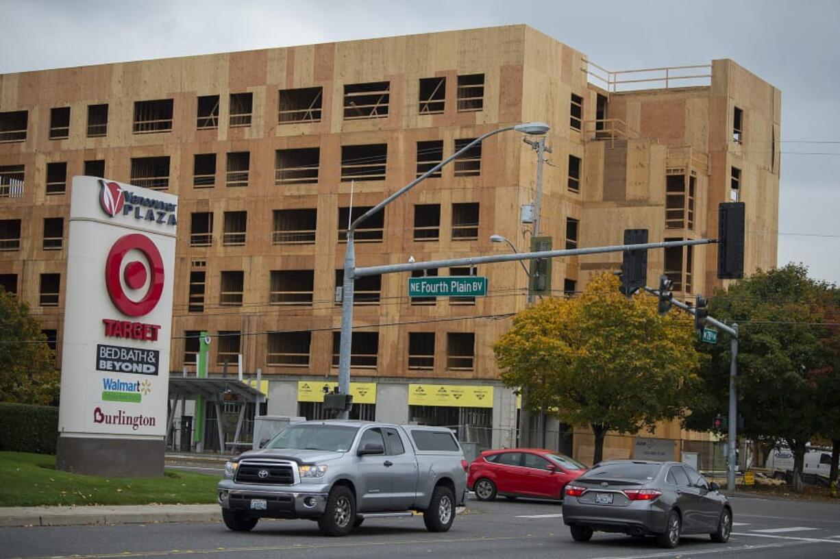 Motorists near the intersection of Northeast Fourth Plain Boulevard and Northeast 78th Avenue pass a six-story, mixed-use building under construction by Sea Mar Community Health Centers. Sea Mar’s housing development will feature health and human services on the first floor. A proposed code amendment would eliminate that first-floor commercial requirement.