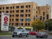 Motorists near the intersection of Northeast Fourth Plain Boulevard and Northeast 78th Avenue pass a six-story, mixed-use building under construction by Sea Mar Community Health Centers. Sea Mar’s housing development will feature health and human services on the first floor. A proposed code amendment would eliminate that first-floor commercial requirement.