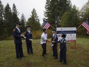 John Snyder, 17, from left, and Nathaniel Garate, 17, both members of the Prairie High School Junior Reserve Officers’ Training Corps, look on as United States Army veteran Rico Roman greets JROTC members Austin Tran, 16, and Ayah Al Baiaty, 17, after the groundbreaking for his new home in Hockinson on Wednesday morning. The Gary Sinise Foundation is building specially adapted smart homes for severely wounded veterans like Roman, who lost his leg while serving his country.