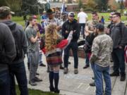 Patriot Prayer leader Joey Gibson and his supporters talk with members of the crowd before he gives a speech Wednesday at Clark College. After the college canceled classes Monday in response to Patriot Prayer’s demonstration on campus, the group returned Wednesday to protest Initiative 1639 and spread its message to students.