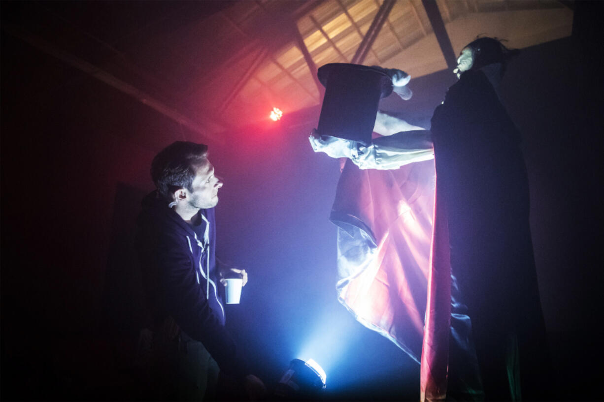 Jason Greeley-Roberts, owner of Scaregrounds at the Clark County Fairgrounds, stops while patrolling a haunt to fix a strobe light on Thursday night.